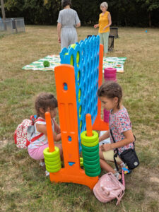 2 young girls just starting to play a connect 4 type game