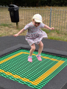 A young girl about 6 years old enjoying jumping on the new in-floor trampoline