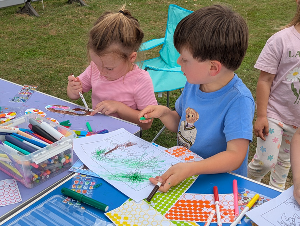 2 children making and colouring in masks
