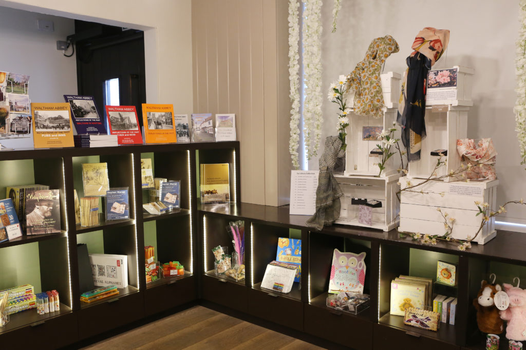 A collection of books, gifts and paintings on the shelves of the museum gift shop