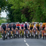 The peloton formed up in team groups rides through the Essex countryside near Weald Bassett