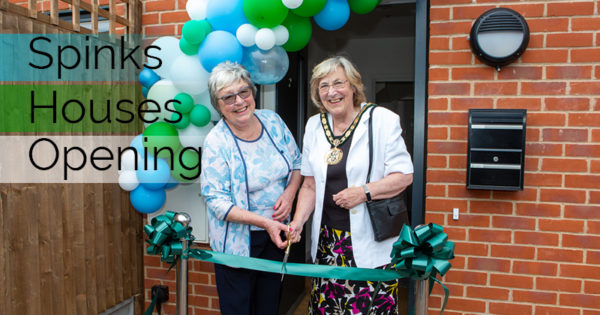 Spinks house opening, Chairman of the council, Mary Sartin and Liz Webster cutting the ribbon outside one of the new builds