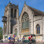 Riders pass St John’s Church in Epping during the Ford RideLondon-Essex 100 from Victoria Embankment on Sunday 28th May 2023.