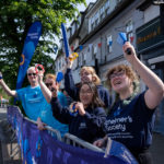 Alzheimer’s Society charity cheer zone spectators cheer on the riders on Epping High Street during the Ford RideLondon-Essex on Sunday 28th May 2023.