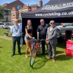 Raffle bike winner Alice Rider receiving her bike from the Chairman Cllr Darshan Sunger, Vice-Chairman Cllr Les Burrows and Cycle King