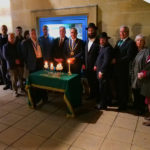 Leading members of the Jewish community and councillors standing by lit candles at Jewish support event